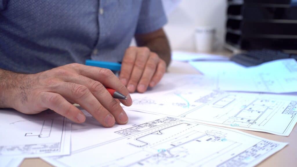 Ingénieurs du Bureau d'Études de Coublanc en train de travailler sur des plans techniques.